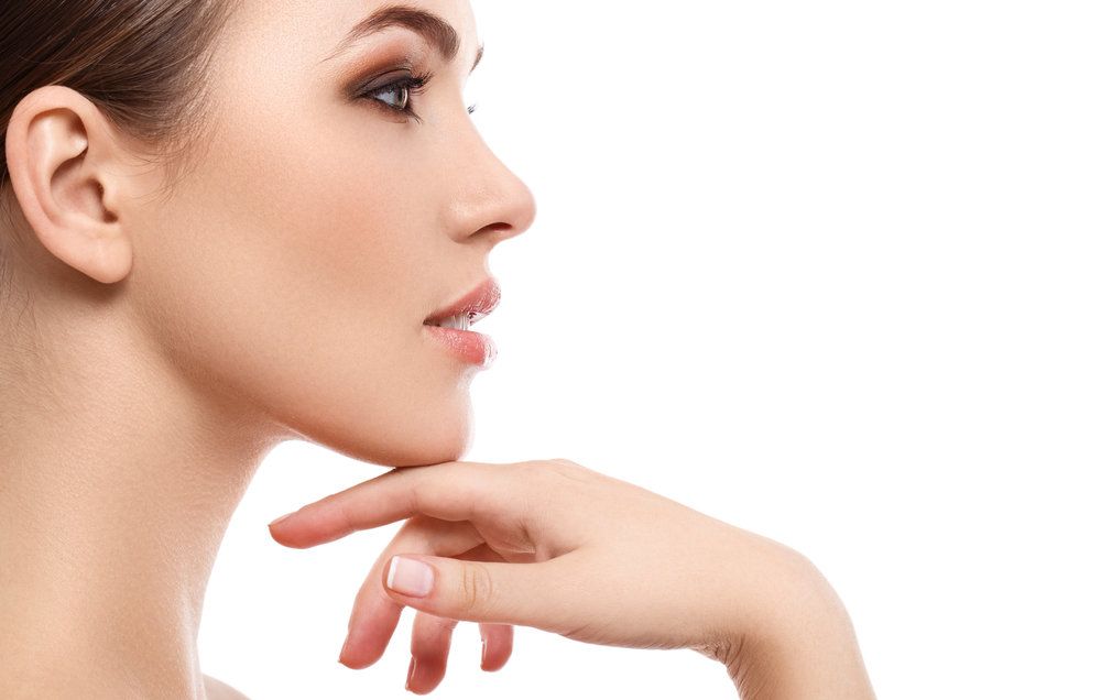 Side profile of a woman with her hand resting under her chin